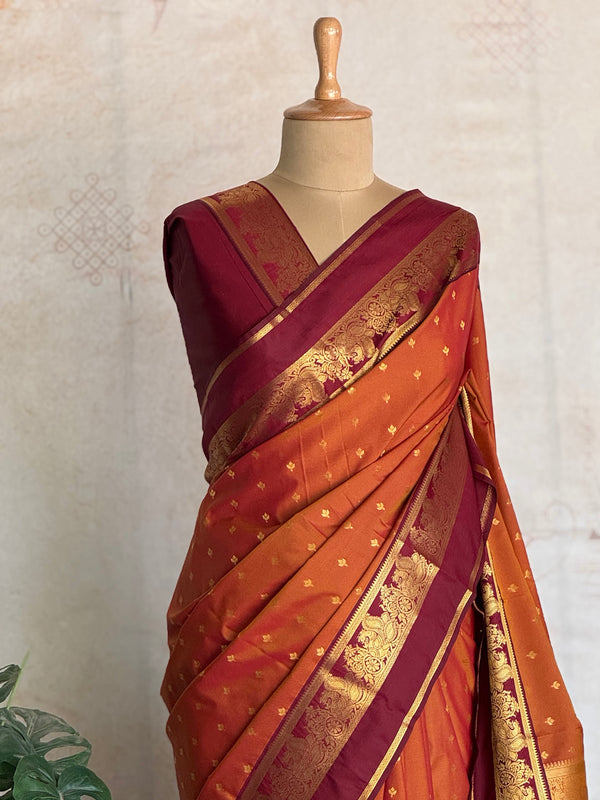 Semi Kanchi Silk Saree in Burnt Orange with Magenta Zari Border & Traditional Buttas
