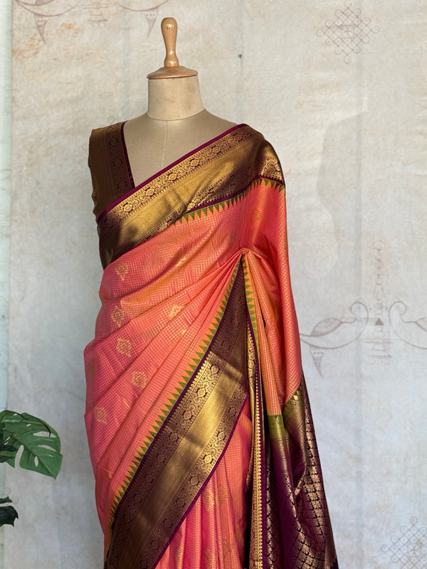 Semi Kanchi Silk Saree in Coral Peach with Antique Gold Zari Border & Contrast Purple Blouse