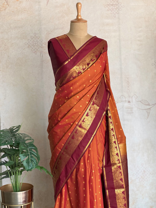 Semi Kanchi Silk Saree in Burnt Orange with Magenta Zari Border & Traditional Buttas