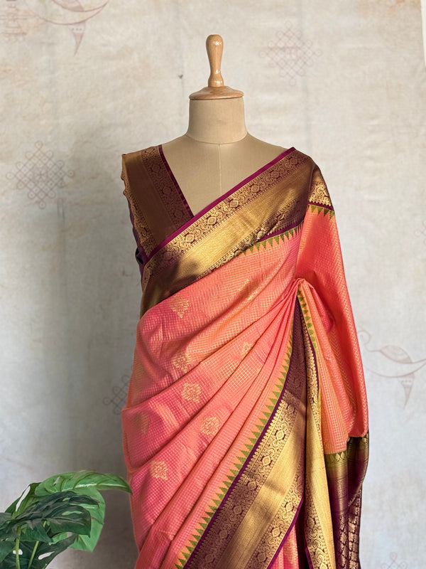 Semi Kanchi Silk Saree in Coral Peach with Antique Gold Zari Border & Contrast Purple Blouse