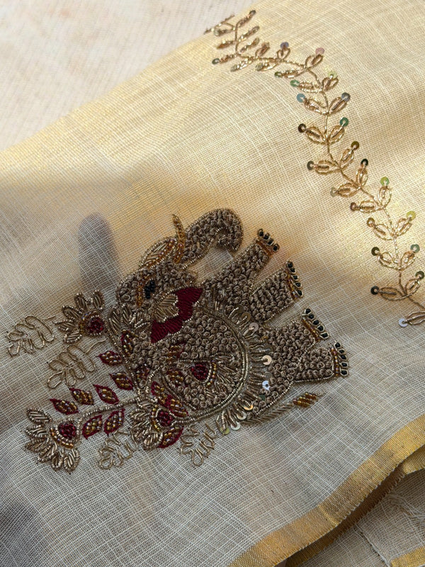 Tejas - Ivory linen saree with hand-embroidered floral & elephant buttas