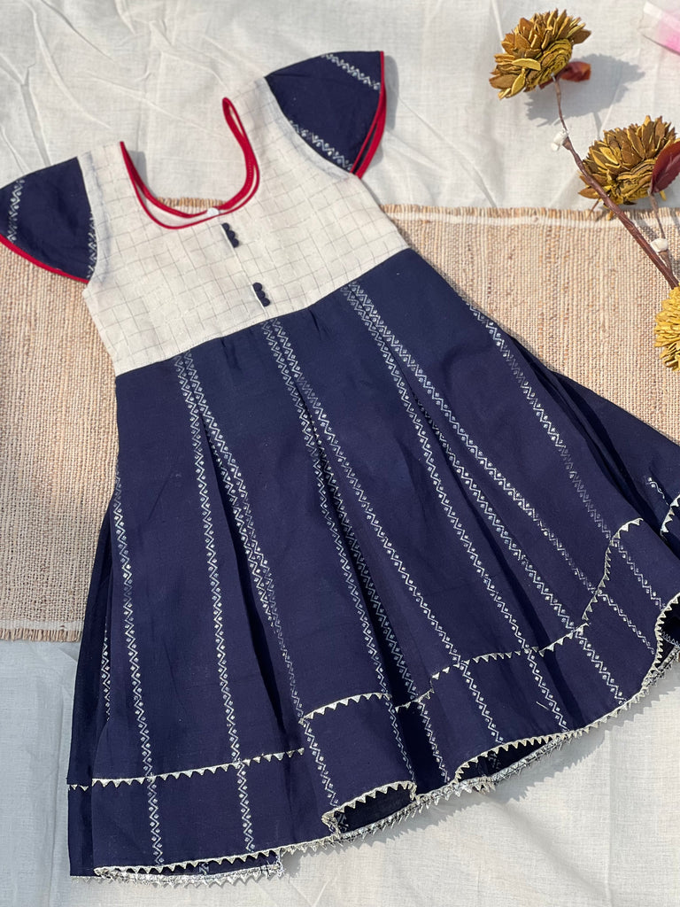 White Blue Sungudi Kids Frock with Zari Kattam | Cotton Ethnic Dress | Studio Virupa White Blue Sungudi Kids Frock with Zari Kattam | Cotton Ethnic Dress | Studio Virupa